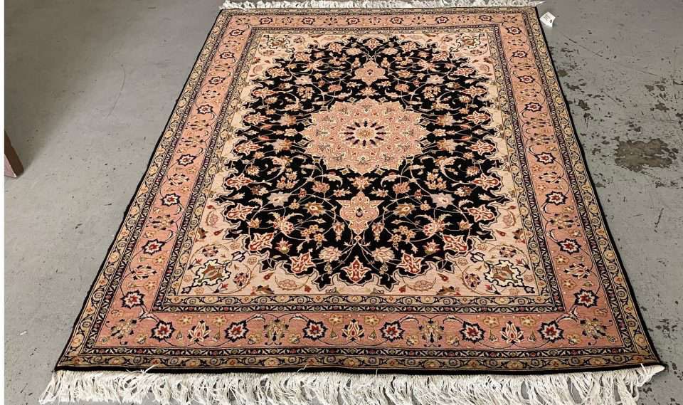 The same Tabriz rug after our 12-step hand-wash — colors restored, pile revived.