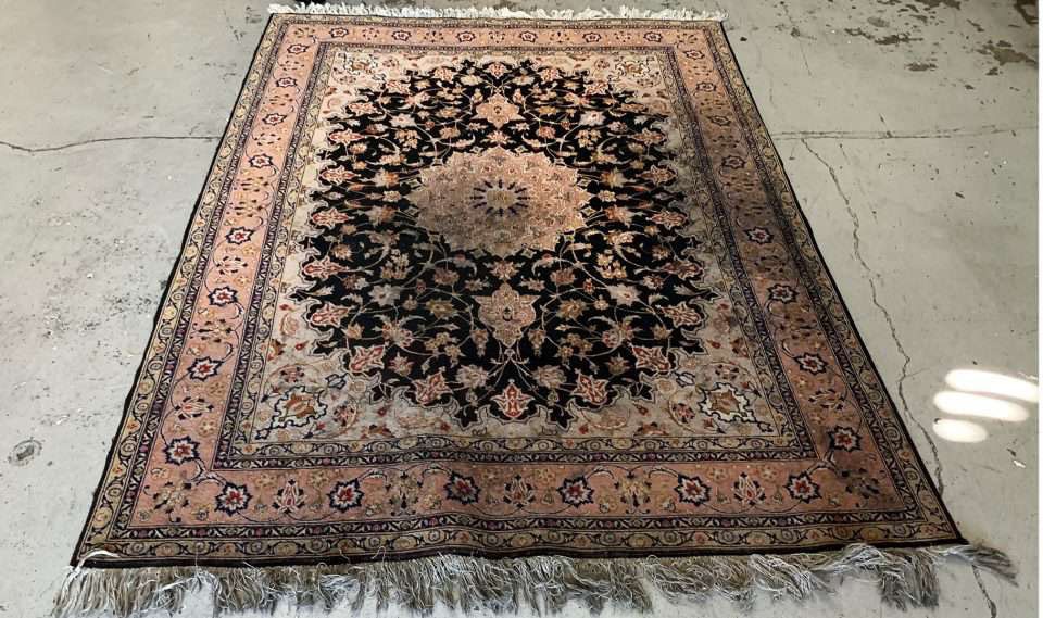 Antique Tabriz rug before cleaning — dulled colors, soiled pile.