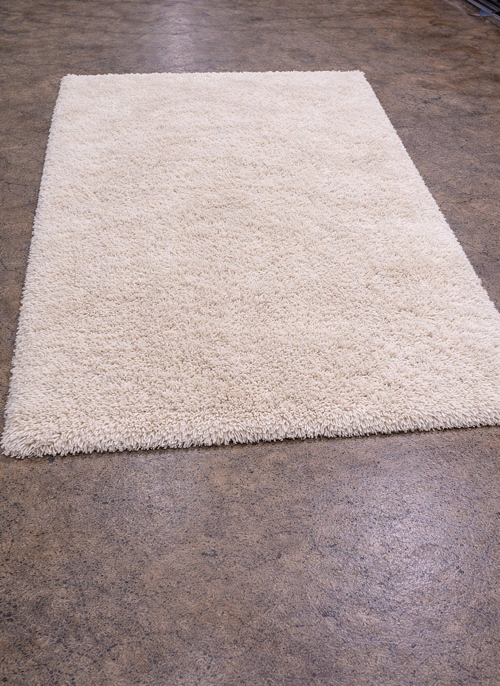 The same cream wool shag rug after our hand wash — pile bright and revived.
