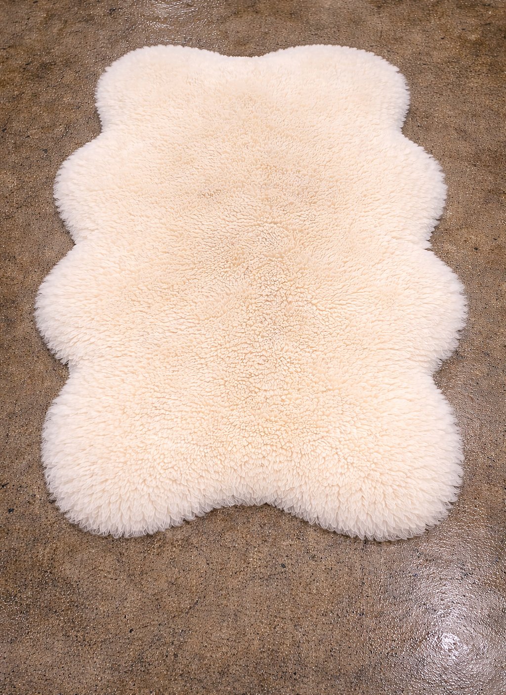 The same cream sheepskin after our hand wash — pile bright and revived.